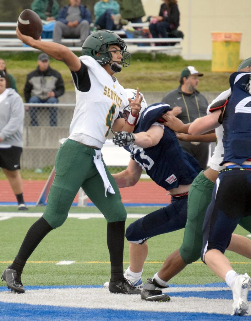 Service quarterback Coen Niclai throws under pressure from Soldotnas Jeren Nash on Friday, Sept. 3, 2021, at Justin Maile Field in Soldotna, Alaska. (Photo by Jeff Helminiak/Peninsula Clarion)
