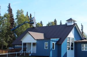 A worker paints a steeple white at the Kenai United Methodist Church on Monday, Sept. 6, 2021 in Kenai, Alaska. (Ashlyn O'Hara/Peninsula Clarion)