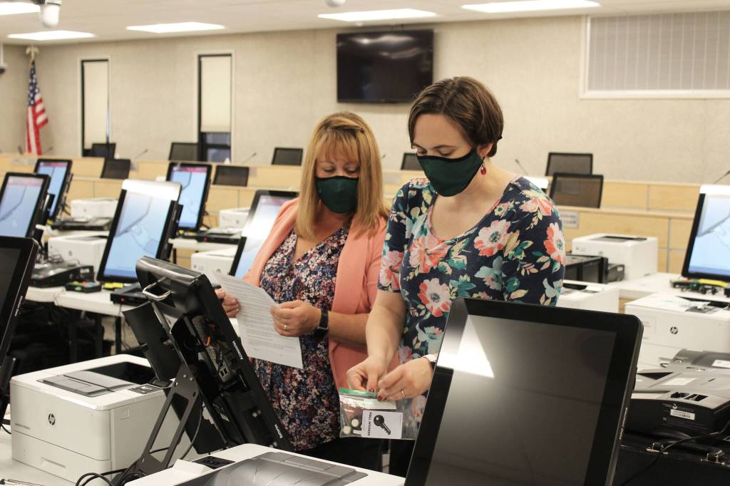 Shellie Saner (left) and Rachel Nash (right) test voting equipment ahead of the Oct. 5 municipal election on Thursday, Sept. 9, 2021 in Soldotna, Alaska. (Ashlyn OHara/Peninsula Clarion)