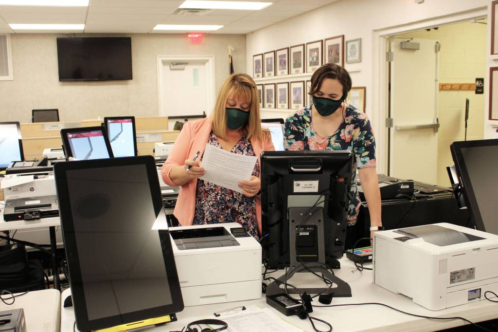 Shellie Saner (left) and Rachel Nash (right) test voting equipment ahead of the Oct. 5 municipal election on Thursday, Sept. 9, 2021 in Soldotna, Alaska. (Ashlyn OHara/Peninsula Clarion)
