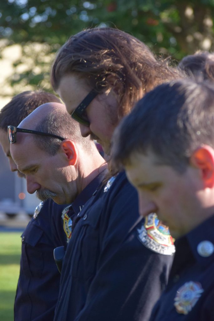 Firefighters bow their heads during the 20th memorial service of the 9/11 terrorist attacks at Central Emergency Services in Soldotna on Saturday, Sept. 11, 2021. (Camille Botello/Peninsula Clarion)