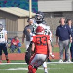 Redingtons Wayde Bowman passes over Kenai Centrals Reagan Graves on Saturday, Sept. 11, 2021, at Kenai Central High School in Kenai, Alaska. (Photo by Jeff Helminiak/Peninsula Clarion)