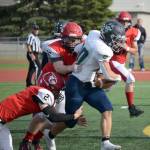 Redingtons Jaden Spaulding slips between two Kardinals for a gain Saturday, Sept. 11, 2021, at Kenai Central High School in Kenai, Alaska. (Photo by Jeff Helminiak/Peninsula Clarion)