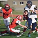 Homer quarterback Carter Tennison tries to avoid the tackle of Kenai Centrals Talon Whicker on Friday, Sept. 17, 2021, at Ed Hollier Field in Kenai, Alaska. (Photo by Jeff Helminiak/Peninsula Clarion)