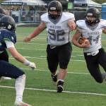 Nikiski's Mayaac Schmit blocks for Truit McCaughey on Friday, Sept. 17, 2021, at Redington High School in Alaska. (Photo by Tim Rockey/Frontiersman)