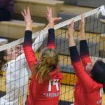 Nikiski's Rylee Ellis puts the ball between Kenai blockers Erin Koziczkowski and Jorgi Phillips during their volleyball game on Tuesday, Sept. 28, 2021, in Nikiski, Alaska. (Camille Botello/Peninsula Clarion)