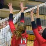 Nikiski's Rylee Ellis puts the ball between Kenai blockers Erin Koziczkowski and Jorgi Phillips during their volleyball game on Tuesday, Sept. 28, 2021, in Nikiski, Alaska. (Camille Botello/Peninsula Clarion)