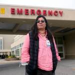 Angelique Ramirez, chief medical officer at Foundation Health Partners in Fairbanks, poses for a photograph in front of the emergency entrance at Fairbanks Memorial Hospital on Tuesday, Sept. 21, 2021, in Fairbanks, Alaska. Fairbanks Memorial Hospital on Friday, Oct. 1, said it activated the Crisis Standards of Care policy because of a critical shortage of bed capacity, staffing and monoclonal antibody treatments, along with the inability to transfer patients to other facilities. (AP Photo/Rick Bowmer)