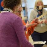 Poll worker Joan Seaman helps Joyce Ellestad cast her vote at Kenai No. 1 precinct on Oct. 5, 2021. (Camille Botello/Peninsula Clarion)