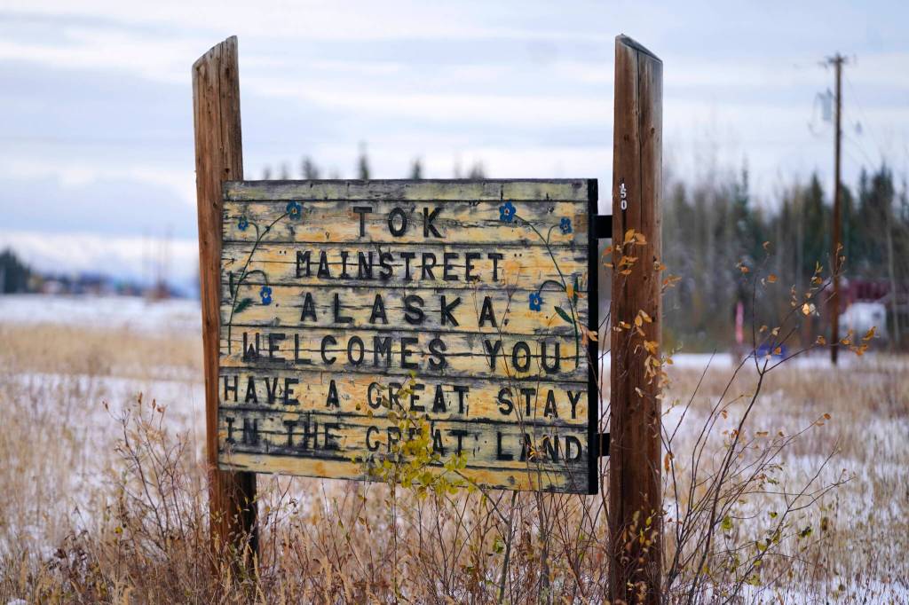A welcome to Tok Mainstreet Alaska sign is shown Wednesday, Sept. 22, 2021, in Tok, Alaska. The state is experiencing one of the sharpest rises in COVID-19 cases in the country, coupled with a limited statewide healthcare system that is almost entirely reliant on Anchorage hospitals. (AP Photo/Rick Bowmer)