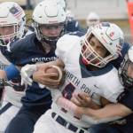Soldotna's Jeren Nash and Wayne Mellon combine to bring down Via Skipps of North Pole on Friday, Oct. 8, 2021, at Justin Maile Field in Soldotna, Alaska. (Photo by Jeff Helminiak/Peninsula Clarion)