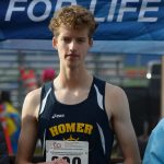 Seamus McDonough of Homer gets a medal at the Division II state cross country championship at Bartlett High School in Anchorage, Alaska on Saturday, Oct. 9, 2021 for his ninth place finish. (Camille Botello/Peninsula Clarion)