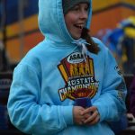 Eryn Field of Homer gets a medal at the Division II state cross country championship at Bartlett High School in Anchorage, Alaska on Saturday, Oct. 9, 2021 for her seventh place finish. (Camille Botello/Peninsula Clarion)