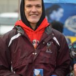 Justin Trail of Nikolaevsk gets a medal at the Division III state cross country championship at Bartlett High School in Anchorage, Alaska on Saturday, Oct. 9, 2021 for his third place finish. (Camille Botello/Peninsula Clarion)