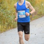 Kenai's Jason Parks, running on Kalifornsky Beach Road in Kenai, Alaska, wins the Kenai River Marathon on Sept. 28, 2019. (Photo by Jeff Helminiak/Peninsula Clarion)
