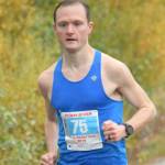 Kenai's Jason Parks, running on Kalifornsky Beach Road in Kenai, Alaska, wins the Kenai River Marathon on Sept. 28, 2019. (Photo by Jeff Helminiak/Peninsula Clarion)