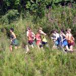 Runners participate in boys varsity race at the Ted McKenney XC Invitational on Saturday, Aug. 21, 2021, at Tsalteshi Trails just outside of Soldotna, Alaska. The trails recently reported incidents of vandalism and theft. (Photo by Jeff Helminiak/Peninsula Clarion)