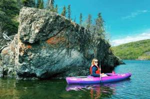 MJ Hendren pictured kayaking at Hidden Lake next to a large rock exposure. (Photo provided)