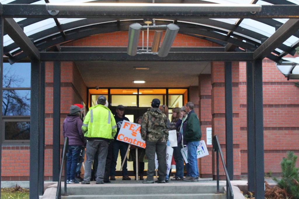 Demonstrators gather outside of Soldotna City Hall to protest COVID-19 mandates on Wednesday, Oct. 13, 2021 in Soldotna, Alaska. (Ashlyn OHara/Peninsula Clarion)