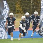 Brock Wilson and Brayden Taylor lead Soldotna onto Justin Maile Field for a Division II semifinal against North Pole on Friday, Oct. 8, 2021, in Soldotna, Alaska. (Photo by Jeff Helminiak/Peninsula Clarion)