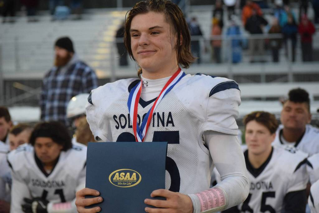 Soldotna sophomore Gehret Medcoff accepts his individual player of the game award after the Division II state football championship against Lathrop at Service High School in Anchorage on Saturday, Oct. 16, 2021.(Camille Botello/Peninsula Clarion)