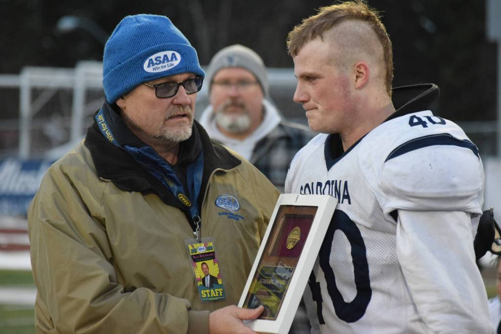 Soldotna senior Dylan Dahlgren accepts the teams academic award after the Division II state football championship game against Lathrop at Service High School in Anchorage on Saturday, Oct. 16, 2021.(Camille Botello/Peninsula Clarion)