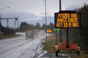 A portable sign on the Sterling Highway advertises a Pfizer COVID-19 vaccinaton booster clinic held 9 a.m. to 1 p.m. Friday, Oct. 15, 2021, at Homer High School in Homer, Alaska. (Photo by Michael Armstrong/Homer News)