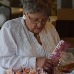 Velda Geller fills goodie bags at the Kenai Senior Center on Friday, Oct. 22, 2021 for next weekends drive-through trick-or-treat event. (Camille Botello/Peninsula Clarion)