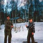 In this 1950s image, Chell Bear (left) and Lawrence McGuire display a stringer of small trout they caught through the ice in front of the homestead cabin of Bob Mackey, for whom the Mackey Lakes were named. (Photo courtesy of the Kenai Peninsula College Historic Photo Repository)