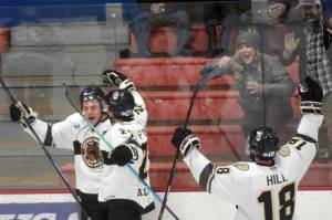 Kenai River Brown Bears forward Caden Triggs (far left) celebrates his first-period goal with Tyler Pfister and Brendan Hill on Friday, Oct. 21, 2021, at the Soldotna Regional Sports Complex in Soldotna, Alaska. (Photo by Jeff Helminiak/Peninsula Clarion)