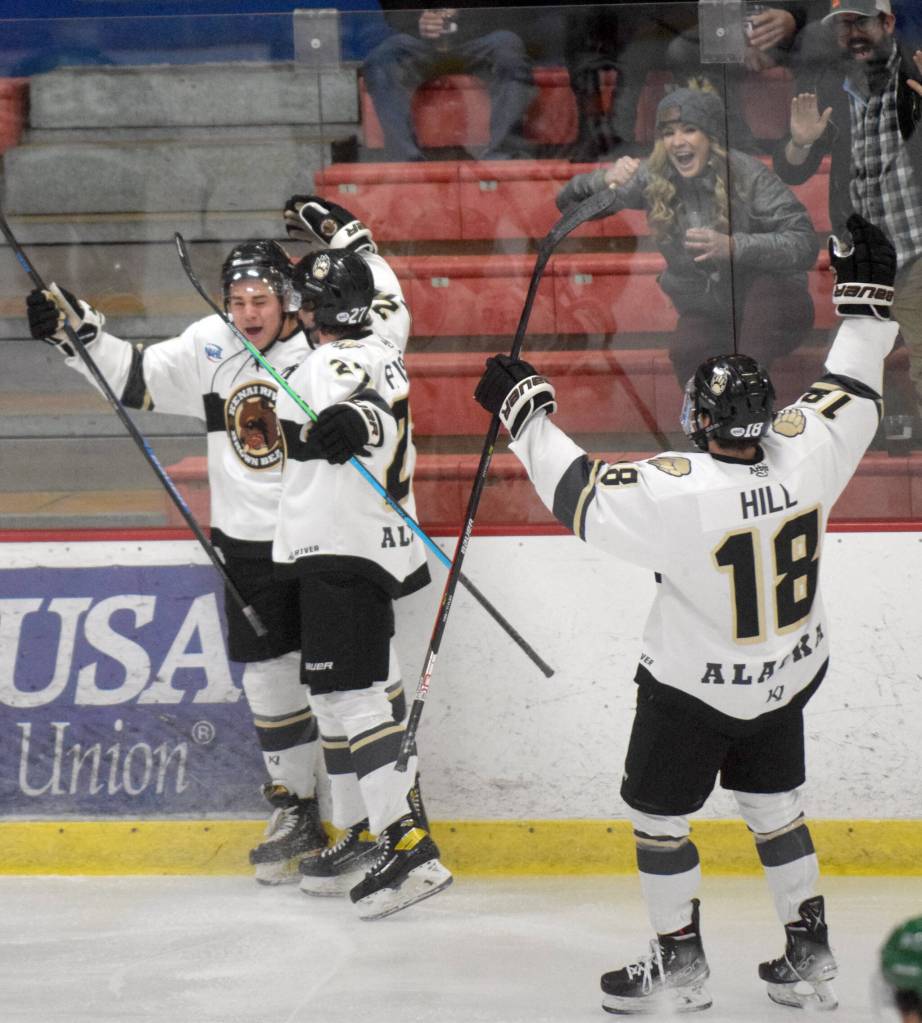 Kenai River Brown Bears forward Caden Triggs (far left) celebrates his first-period goal with Tyler Pfister and Brendan Hill on Friday, Oct. 21, 2021, at the Soldotna Regional Sports Complex in Soldotna, Alaska. (Photo by Jeff Helminiak/Peninsula Clarion)