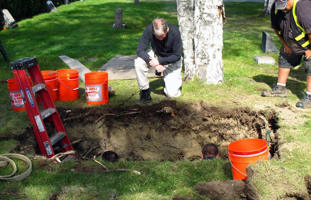 In this Sept. 3, 2014, file photo, workers and medical examiner crew members exhume the body of Jane Doe #3 from a cemetery in Anchorage, Alaska. The remains of a woman known for 37 years only as Horseshoe Harriet, one of 17 victims of a notorious Alaska serial killer, have been identified through DNA profiling as Robin Pelkey, authorities said Friday, Oct. 22, 2021. (AP Photo/Rachel DOro, File)
