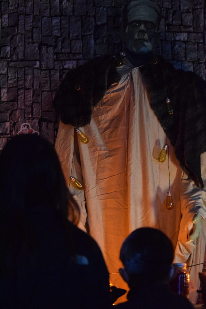 Heather and Hunter Phillips walk through the Kenai Community Library Haunted Hunt on Tuesday, Oct. 26, 2021. (Camille Botello/Peninsula Clarion)