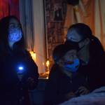Heather and Hunter Phillips walk through the Kenai Community Library Haunted Hunt with their mom Kumi Phillips on Tuesday, Oct. 26, 2021. (Camille Botello/Peninsula Clarion)