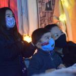 Heather and Hunter Phillips walk through the Kenai Community Library Haunted Hunt with their mom Kumi Phillips on Tuesday, Oct. 26, 2021. (Camille Botello/Peninsula Clarion)