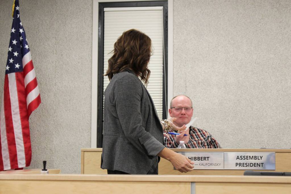 Kenai Peninsula Borough Clerk Johni Blankenship collects a ballot from assembly member Brent Hibbert on Tuesday, Oct. 26, 2021 in Soldotna, Alaska. The assembly elected a new president and vice president during a meeting on Tuesday. (Photo by Ashlyn OHara/Peninsula Clarion)