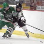 Jax Schauer of the Chippewa (Wisconsin) Steel and Dylan Evans of the Kenai River Brown Bears battle for the puck Friday, Oct. 21, 2021, at the Soldotna Regional Sports Complex in Soldotna, Alaska. (Photo by Jeff Helminiak/Peninsula Clarion)