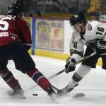 Love Bergvall of the Fairbanks Ice Dogs and Max Marquette of the Kenai River Brown Bears battle for the puck Friday, Oct. 29, 2021, at the Soldotna Regional Sports Complex in Soldotna, Alaska. (Photo by Jeff Helminiak/Peninsula Clarion)
