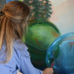 Melinda Hershberger works on her installation for the Kenai Art Centers collaborative mural project on Wednesday, Nov. 3, 2021. (Camille Botello/Peninsula Clarion)