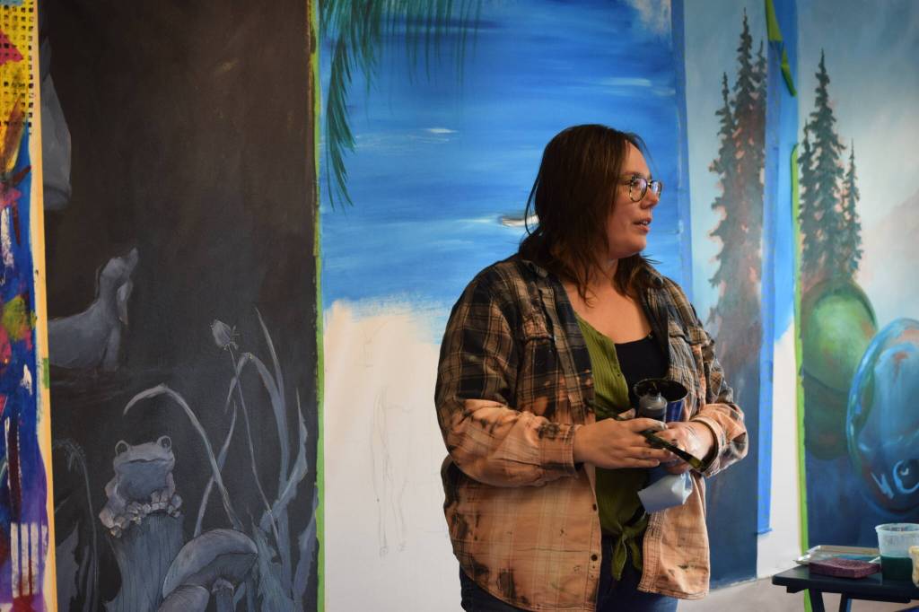 Abbey Ulen works on her installation for the Kenai Art Centers collaborative mural project on Wednesday, Nov. 3, 2021. (Camille Botello/Peninsula Clarion)