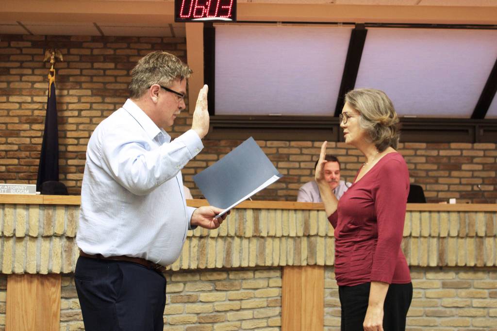 Kenai Mayor Brian Gabriel (left) swears in Kenai City Council Member Deborah Sounart during a meeting of the Kenai City Council on Wednedsay, Nov. 3, 2021 in Kenai, Alaska. (Ashlyn OHara/Peninsula Clarion)