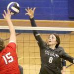 Soldotna's Adarra Hagelund reaches to try to block a hit by Wasilla's Bella Hays during a 3-0 win over the Warriors on the first day of the Northern Lights Conference tournament Friday, Nov. 4, 2021, at Palmer High School. (Jeremiah Bartz/Frontiersman)