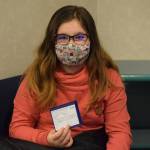 Madyson Knudsen, 10, holds up her COVID-19 vaccine card after receiving her first pediatric shot the Kenai Public Health Center on Friday, Nov. 5, 2021. The Centers for Disease Control and Prevention extended the emergency use authorization of the Pfizer-BioNTech vaccine to include kids ages 5 to 11 this week. (Camille Botello/Peninsula Clarion)