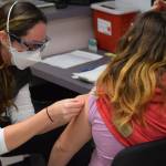 Nurse Sherra Pritchard gives Madyson Knudsen a bandage at the Kenai Public Health Center after the 10-year-old received her first COVID-19 vaccine on Friday, Nov. 5, 2021. The Centers for Disease Control and Prevention extended the emergency use authorization of the Pfizer-BioNTech vaccine to include kids ages 5 to 11 this week. (Camille Botello/Peninsula Clarion)