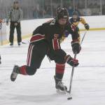 Kenai Centrals Jacob Begich moves the puck against Homer on Friday, Nov. 6, 2021, at the Kevin Bell Arena in Homer, Alaska. (Photo by Sarah Knapp/Homer News)