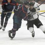 Anchorage Wolverines defenseman Danny Reis and Kenai River Brown Bears defenseman Carter Green battle for the puck Friday, Nov. 5, 2021, at the Soldotna Regional Sports Complex in Soldotna, Alaska. (Photo by Jeff Helminiak/Peninsula Clarion)