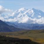 Sightseeing buses and tourists are seen at a pullout popular for taking in views of North Americas tallest peak, Denali, in Denali National Park and Preserve, Alaska, on Aug. 26, 2016. A Utah doctor is accused of lying to get a high-elevation helicopter to rescue him off the tallest mountain in North America and then destroying evidence. Dr. Jason Lance, who is a radiologist in Ogden, Utah, faces three misdemeanors, interfering with and violating the order of a government employee and for filing a false report from his May 2021, attempt to summit Denali, located about 180 miles north of Anchorage. (AP Photo/Becky Bohrer, File)