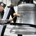 U.S. Coast Guard veteran Jim Wilcox Sr. strikes a replica of the Liberty Bell in front of the Alaska State Capitol on Nov. 11, 2021, during an Armistice Day celebration hosted by Veterans for Peace. The local VFP chapter holds bell ringings annually on Nov. 11, which is also Veterans Day, to remember all the lives lost to war and to call for world peace. (Peter Segall / Juneau Empire)