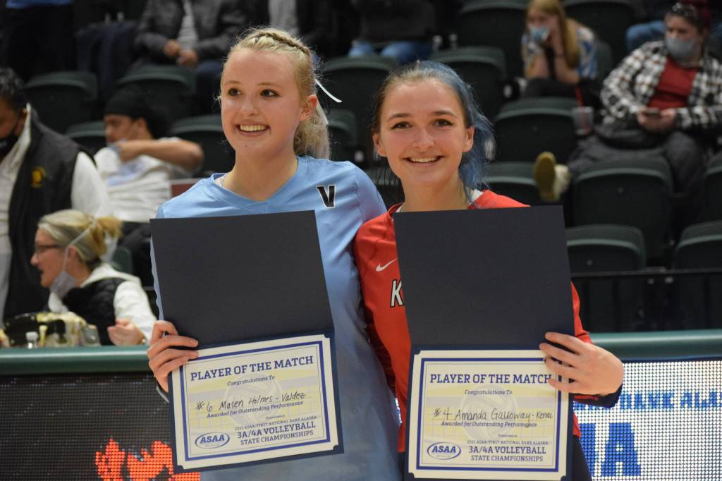 Valdezs Masen Holmes and Kenais Andie Galloway win the players of the match award at the end of the 3A state volleyball championships at the Alaska Airlines Center in Anchorage on Saturday, Nov. 13, 2021. (Camille Botello/Peninsula Clarion)