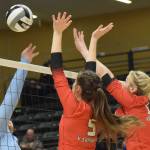 Valdez hitter Momoe Togaage attacks against Kenai blockers Brooke Ashley and Calani Holmes during the 3A state volleyball championship game at the Alaska Airlines Center in Anchorage, Alaska, on Saturday, Nov. 13, 2021. (Camille Botello/Peninsula Clarion)
